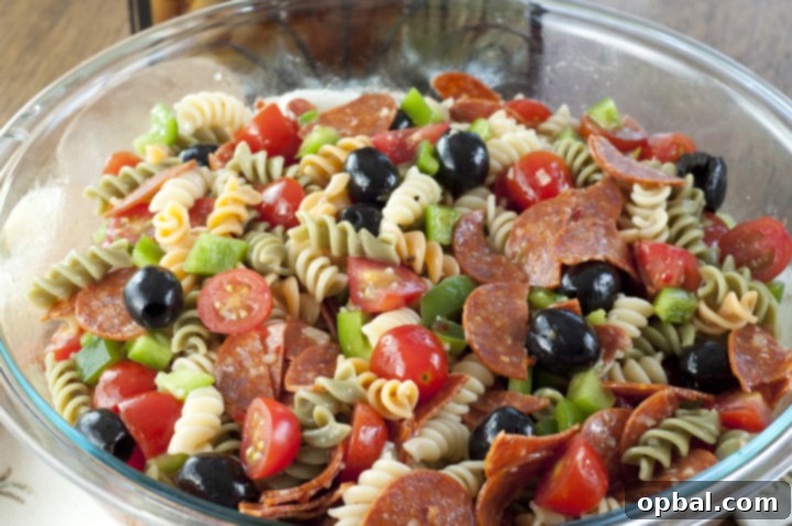 Authentic Italian Pasta Salad 3 Close-up of Classic Italian Pasta Salad with pepperoni, provolone, and fresh vegetables, ideal for Memorial Day, 4th of July, or any summer gathering.