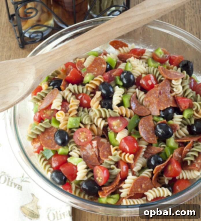 Authentic Italian Pasta Salad 4 Classic Italian Pasta Salad with fusilli, perfect as a vibrant side dish for Memorial Day, 4th of July, or any summer occasion, showcasing its fresh ingredients.