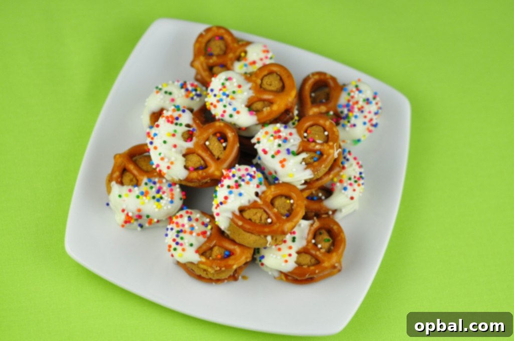 White Chocolate Biscoff Pretzel Bites Delicious White Chocolate Biscoff Pretzel Bites on a serving tray, garnished with sprinkles.