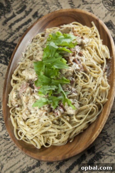 Signature Bellagio Chicken 4 Creamy Chicken Bellagio dinner Cheesecake Factory recipe is chicken and pasta dish with crispy, juicy pan-fried chicken, spaghetti coated in a creamy Parmesan pesto cream sauce and topped with prosciutto and arugula!
