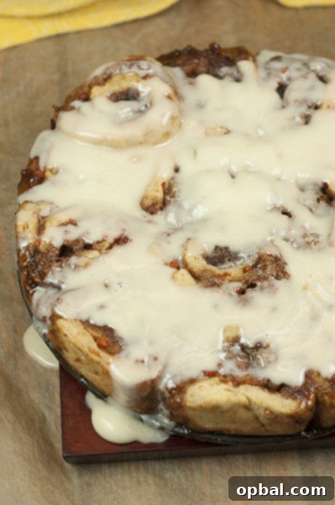 Homemade Carrot Cake Cinnamon Rolls with Mascarpone Icing, freshly baked and glazed, ideal for Easter celebrations.