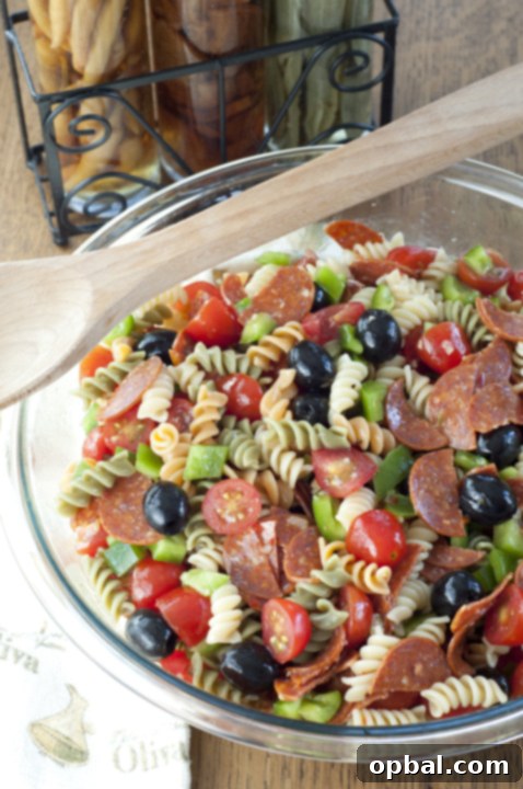 The 103rd Weekly Meal Guide 2 Vibrant Classic Italian Pasta Salad with fresh vegetables, cheese, and salami, perfect for summer gatherings and 4th of July celebrations.