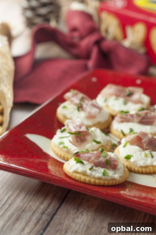 Elegant Whipped Ricotta Prosciutto Crisps 3 Discover the secret to effortless holiday entertaining with Whipped Ricotta Prosciutto Cracker Bites. These festive appetizers are incredibly easy to assemble, featuring creamy whipped ricotta, savory prosciutto, and a crisp cracker base.