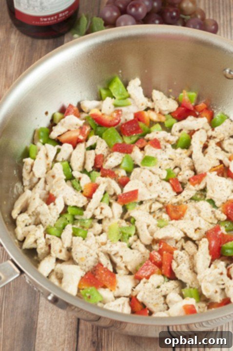 Signature Spicy Chicken Riggies 5 Preparing the chicken and peppers for the Spicy Chicken Riggies.