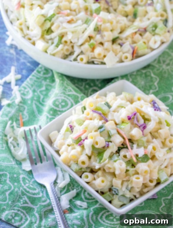Homestyle Macaroni Slaw 4 Generous serving of Macaroni Coleslaw Salad in a bowl, highlighting its fresh ingredients and creamy texture.