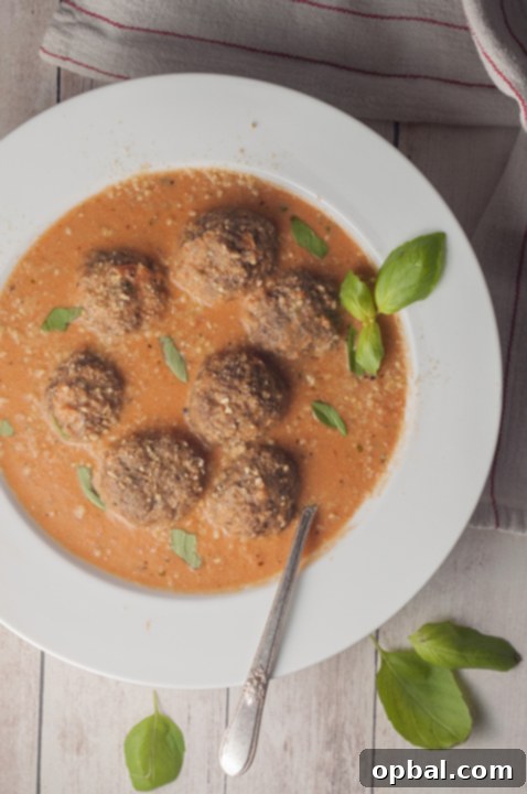 Hearty Tomato Basil Bisque with Italian Meatballs, a comforting and rich soup perfect for fall evenings.