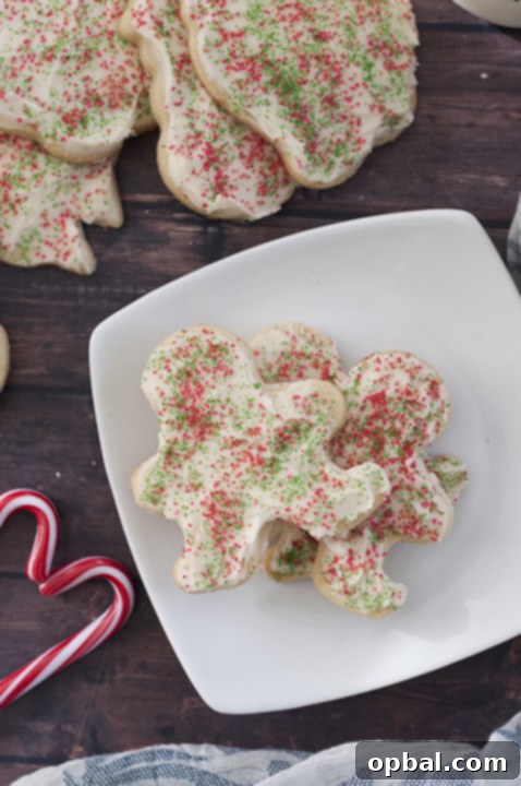 Classic Cutout Cookie Perfection 4 Assortment of festive cut-out sugar cookies with colorful buttercream frosting and sprinkles, a joyful holiday treat.