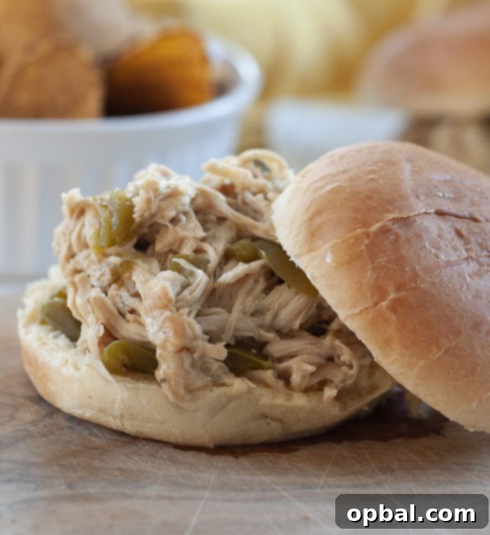 Slow Cooker Philly Cheesesteak Chicken Sandwiches 3 Close-up of shredded cheesesteak chicken with melted white cheddar cheese, fresh from the slow cooker