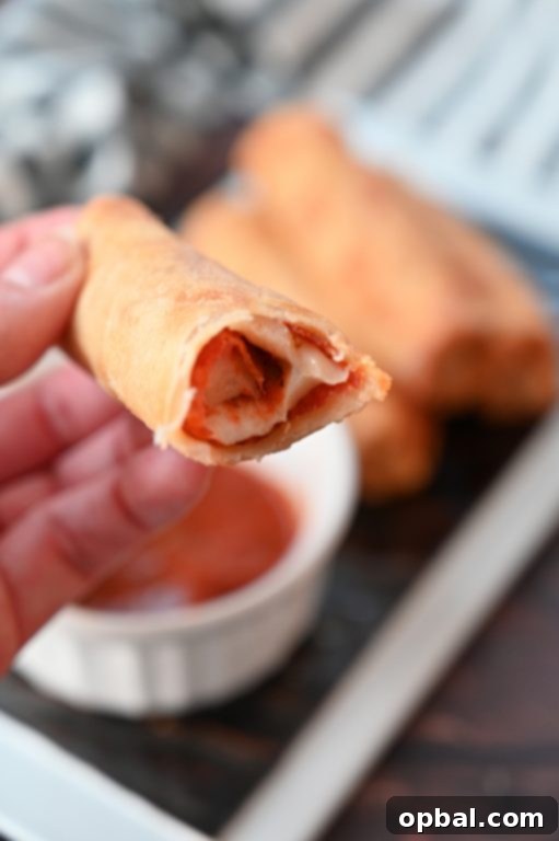 Golden-Baked Pepperoni Pizza Poppers 4 Baked Pepperoni Pizza Rolls recipe with egg roll wrappers, resembling delicious pizza logs from diners or burger spots. These rolls are baked, not fried!