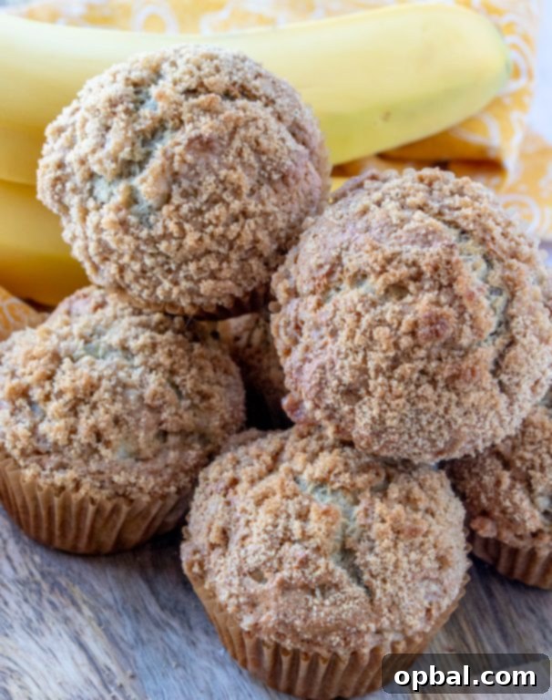 Two enticing banana crumb muffins, showcasing their inviting texture and delicious streusel topping.