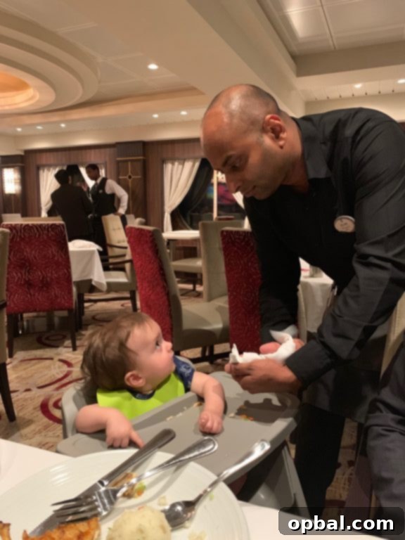 Baby on Board Your Guide to a Family Cruise 11 Fun waitstaff with the baby at the main dining room on board Royal Caribbean Symphony of the Seas cruise.