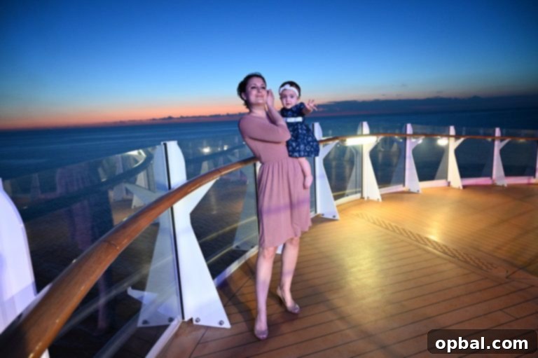 Baby on Board Your Guide to a Family Cruise 3 Family walking at night during Royal Caribbean Symphony of the Seas Caribbean cruise.