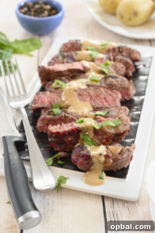 Charred Ribeye with Bold Blue Cheese Onion Cream 2 Perfectly grilled ribeye steak with a generous dollop of creamy onion blue cheese sauce, ready for a summer cookout.