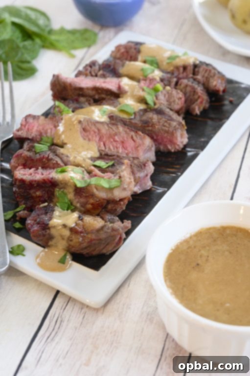 Charred Ribeye with Bold Blue Cheese Onion Cream 6 A beautifully plated grilled ribeye steak with a generous serving of onion blue cheese sauce, ready to be enjoyed.