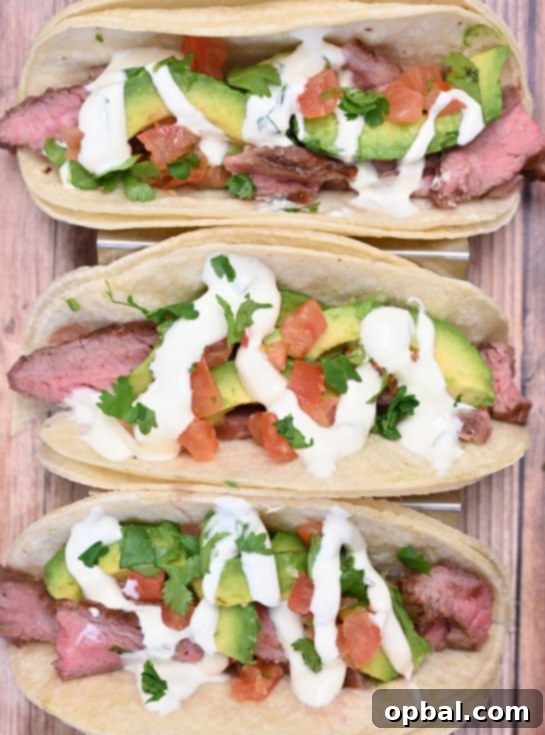 Sizzling Flank Steak Tacos with Cool Avocado and Bright Cilantro Lime Crema 2 Delicious grilled flank steak tacos with vibrant avocado and creamy cilantro lime crema, perfect for a quick weeknight dinner or a relaxed weekend meal.