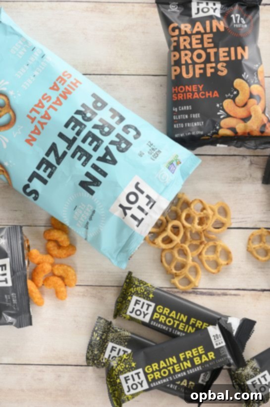 Blueberry Brie Pecan Salad with Crispy Protein Puffs 8 Assortment of FitJoy grain-free pretzels, protein puffs, and protein bars.