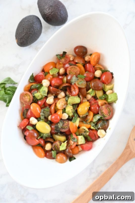 Creamy Caprese Avocado Medley 4 Delicious Caprese Avocado Salad ready to serve, featuring a generous portion of all ingredients