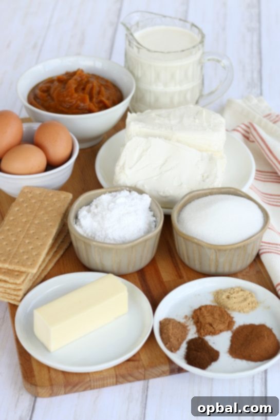 Pumpkin Spice Cheesecake Bars 4 All the essential ingredients meticulously laid out to make Pumpkin Cheesecake Bars, including graham cracker crumbs, sugar, butter, cream cheese, ground cinnamon, ground ginger, ground cloves, eggs, pumpkin puree, ground nutmeg, pumpkin pie spice, heavy whipping cream, and powdered sugar.