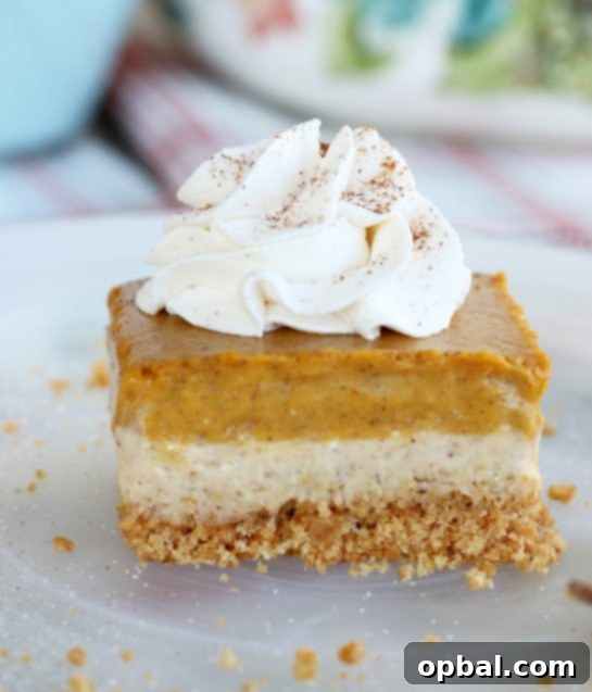 Pumpkin Spice Cheesecake Bars 5 This incredible pumpkin cheesecake bars recipe features a rich, buttery graham cracker crust, a smooth cream cheese layer, and a delightful pumpkin cream cheese layer, making it an ideal fall dessert choice!