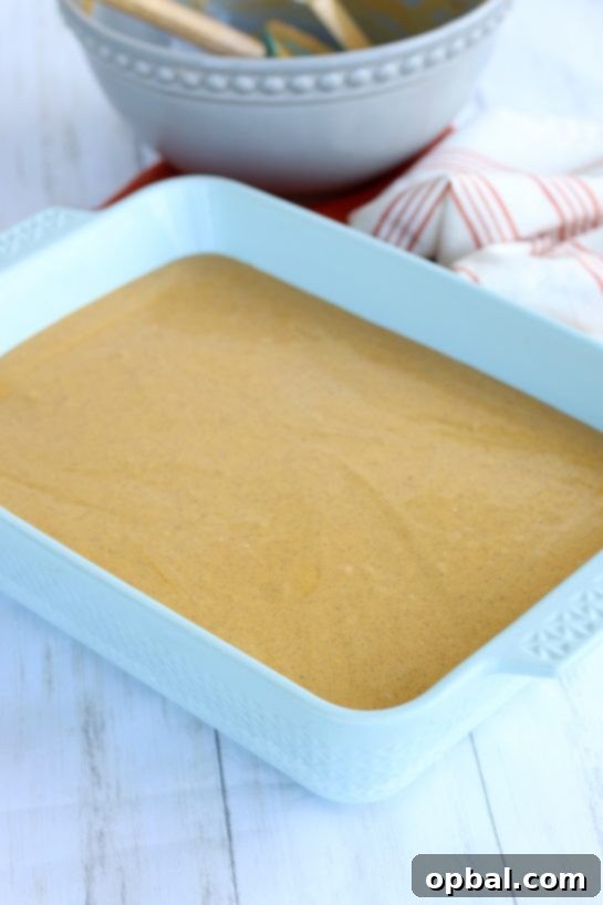 Pumpkin Spice Cheesecake Bars 10 The final pumpkin cream cheese layer expertly added, completing the delicious Pumpkin Cream Cheese Bars.