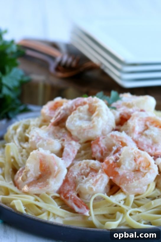 Garlic Butter Shrimp in a Velvety Cream Sauce 3 Close-up view of perfectly cooked garlic butter shrimp bathed in a rich, creamy sauce, garnished with fresh herbs and ready to be eaten. A truly enticing dinner option.
