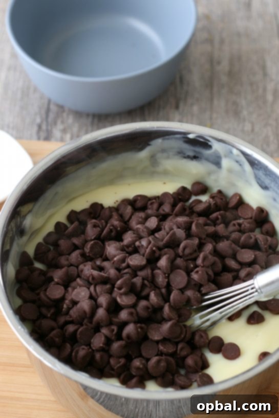 Decadent Chocolate Silk Pie 8 Delectable chocolate chips are generously folded into the warm, luscious homemade chocolate pudding mixture, enhancing its rich flavor.