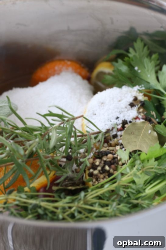 The Ultimate Guide to Brining a Juicy Turkey 6 A close-up view of the turkey brine mixture, featuring herbs and spices submerged in the liquid.