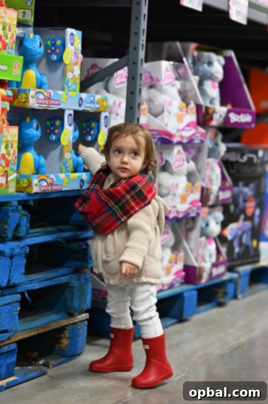 Elevate Your Holiday Entertaining with BJ's 21 Toddler girl shopping for toys at BJ's Wholesale Club