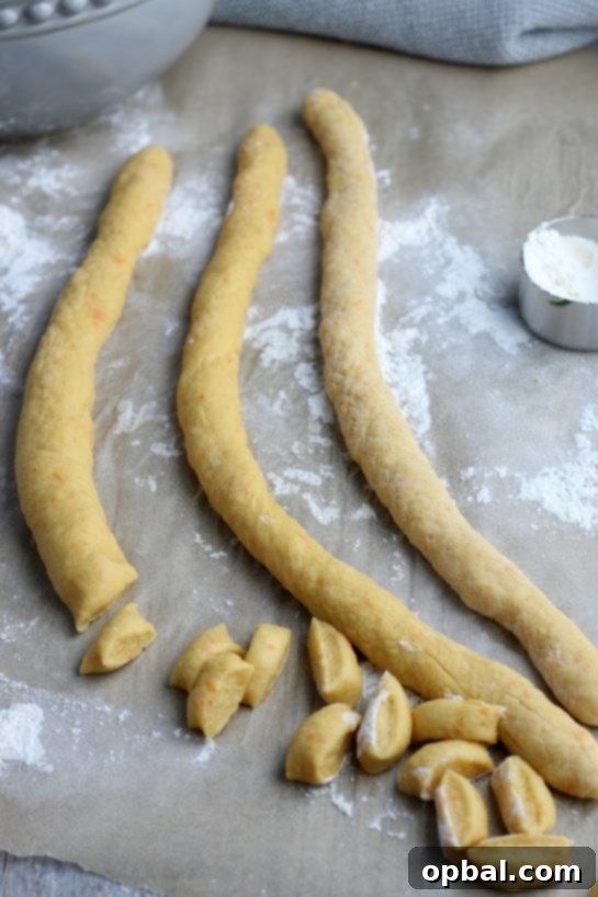 Golden Struffoli: Italian Honey Delights 7 The dough is rolled out and cut into bite sized pieces which will form the struffoli dough balls.