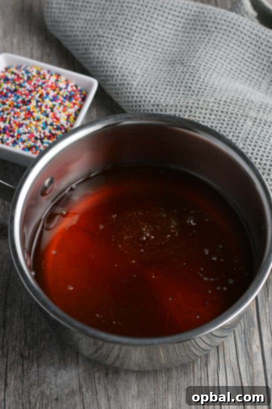 Golden Struffoli: Italian Honey Delights 8 Here we see the glaze and the sprinkles for the topping are in the background, this is what gives the struffoli its sweetness.