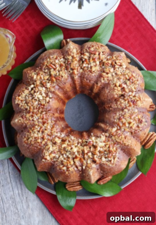 Holiday Spirit Rum Cake 2 A top-down shot of a beautifully glazed rum cake, garnished with pecans and ready to be sliced and served.