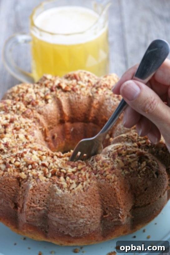 Holiday Spirit Rum Cake 11 A fork being used to pierce the warm rum cake, creating channels for the rum cake glaze to penetrate.