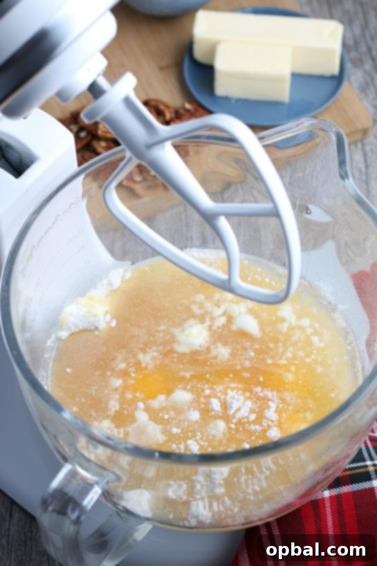 Holiday Spirit Rum Cake 5 The initial wet ingredients being combined in a stand mixer, beginning the process of making the rum cake batter.