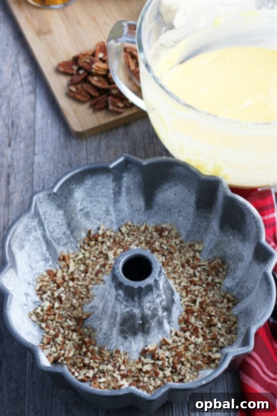 Holiday Spirit Rum Cake 7 A bundt pan, meticulously prepared with non-stick spray and flour, ready to receive the rum cake batter.