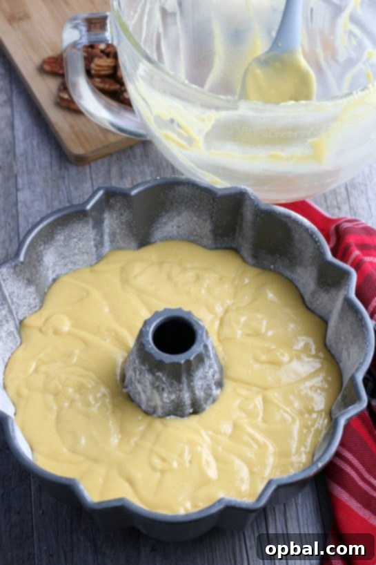 Holiday Spirit Rum Cake 8 The filled bundt pan, brimming with rum cake batter, poised to enter the oven for baking.