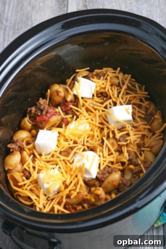 Easy Crockpot Creamy Taco Pasta 11 Cheese goes on top at the very end to make our Mexican pasta in the slow cooker extra cheesy and delicious!