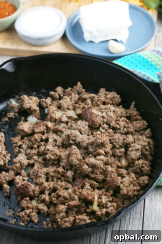 Easy Crockpot Creamy Taco Pasta 5 The first step in our taco pasta recipe is to fry up our ground meat and onions in a skillet.