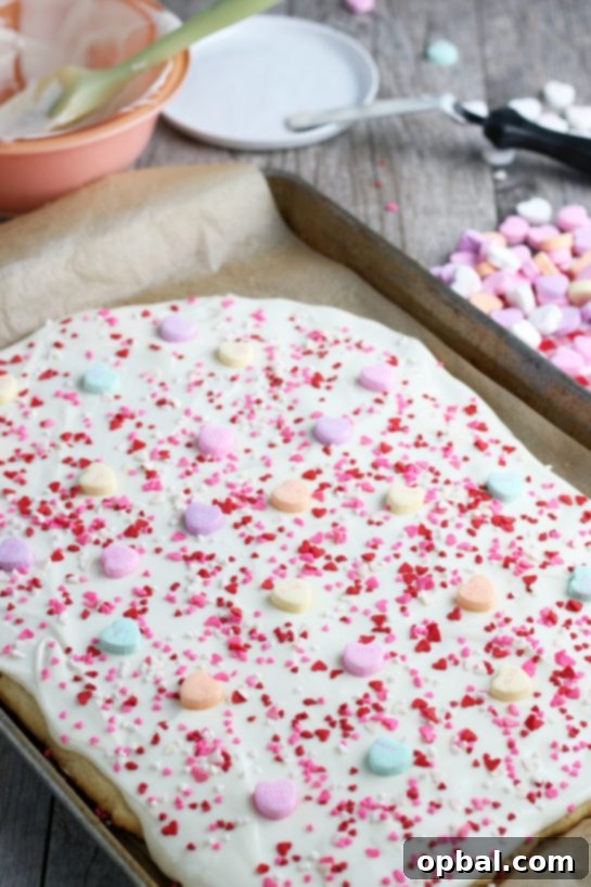 Now we add the conversation hearts to the cookie bark to finish it off, creating a beautiful and festive treat.