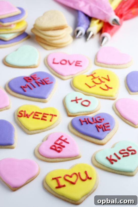 Crafting Edible Love Notes: Decorating Valentine's Conversation Heart Cookies 2 A heartwarming display of Valentine's Day conversation heart cookies, some fully decorated, others awaiting their sweet messages and final touches of royal icing.