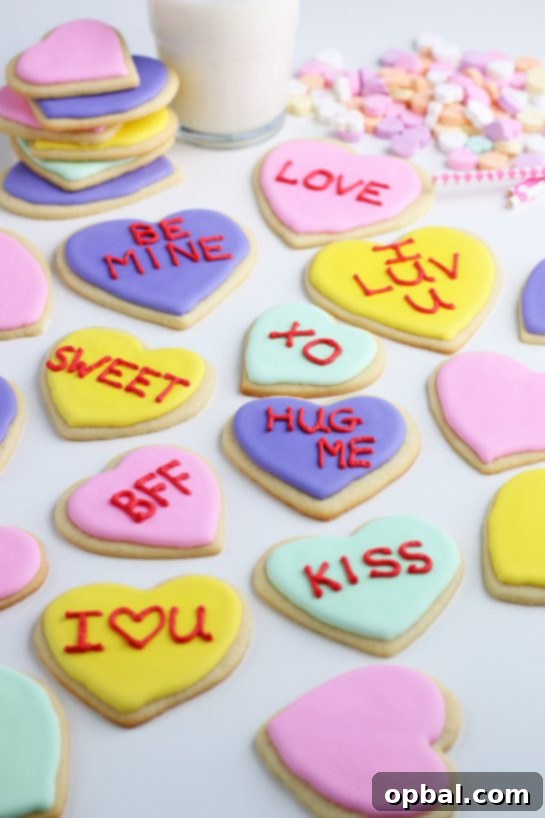 Crafting Edible Love Notes: Decorating Valentine's Conversation Heart Cookies 12 An array of exquisitely decorated sugar cookies, each showcasing a different design and message crafted with colorful royal icing, illustrating the delightful variety that can be achieved when mastering cookie decoration techniques.