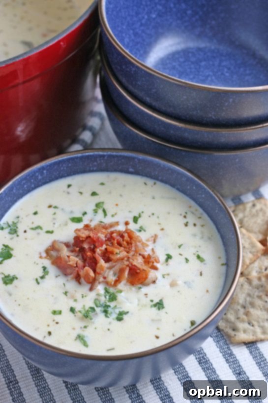New England's Hearty Clam Bliss 2 A bowl of soup with crispy bacon added on top ready to be enjoyed.