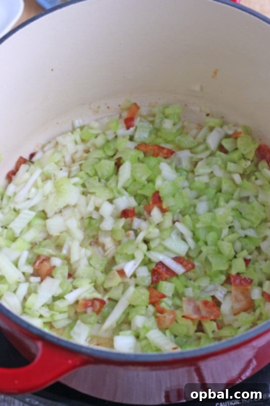 New England's Hearty Clam Bliss 7 Now the vegetables, bacon, and seasonings are mixing within in pot as we make our New England clam chowder recipe.