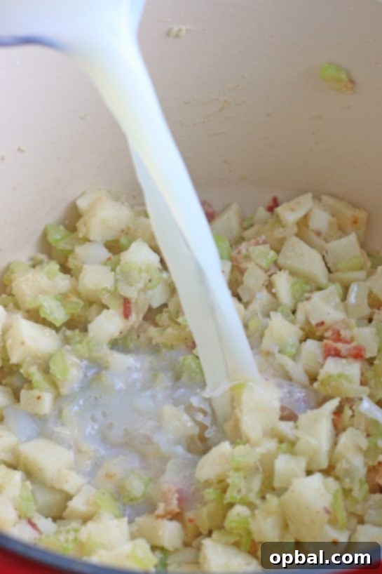 New England's Hearty Clam Bliss 10 Image shows the liquid being added to make the broth of our New England clam chowder recipe.