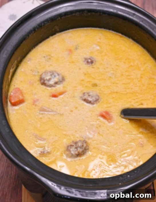 Slow Cooker Cheesy Meatball Soup an easy weeknight family dinner recipe everyone will love. It is a soup recipe that is delicious on a cold winter day!