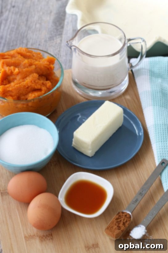 Velvet Sweet Potato Pie 4 All the necessary ingredients for making sweet potato pie are neatly laid out on a kitchen counter, ready for preparation.