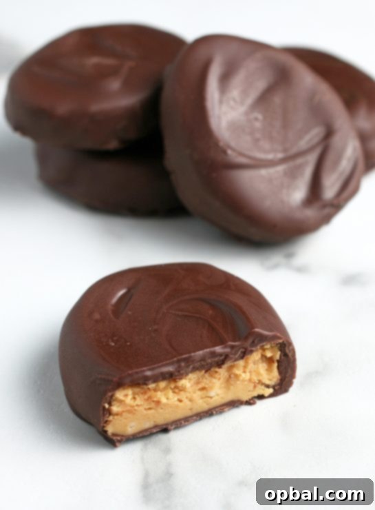 Decadent Chocolate Peanut Butter Eggs 16 A mouth-watering close-up of the finished chocolate peanut butter eggs, beautifully laid out, some cut open to reveal their creamy centers, all ready to be enjoyed for Easter!