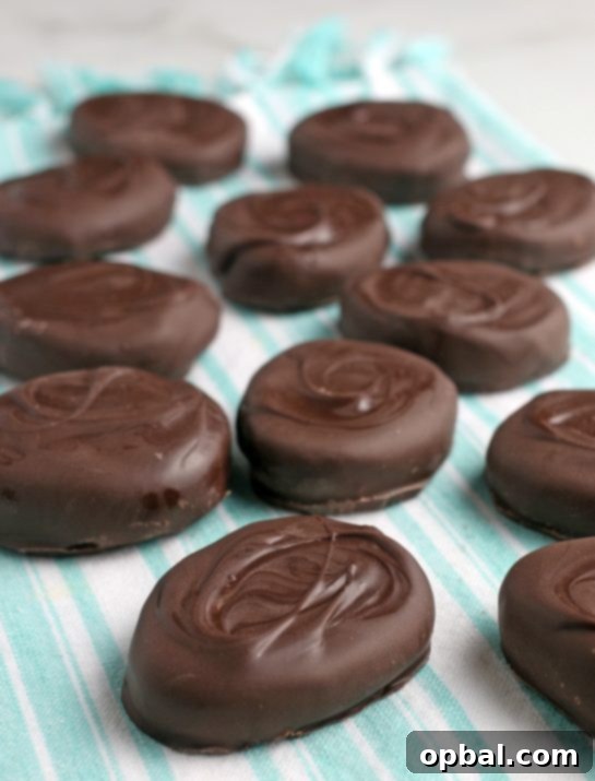 Decadent Chocolate Peanut Butter Eggs 3 A close-up shot of several finished chocolate peanut butter eggs, looking incredibly appetizing and perfectly coated, ready for tasting.