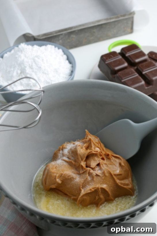 Decadent Chocolate Peanut Butter Eggs 5 The initial step of the recipe: blending the wet ingredients – peanut butter, melted butter, and salt – until smooth and fully combined.