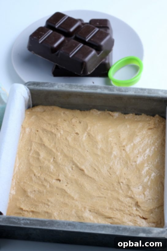Decadent Chocolate Peanut Butter Eggs 9 The peanut butter batter is evenly pressed into a square pan, now ready to be placed in the freezer until it becomes firm.