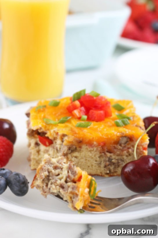 Savory Sleep-In Breakfast Bake 2 One serving of the breakfast egg casserole on a plate with a bite on a fork ready for eating!